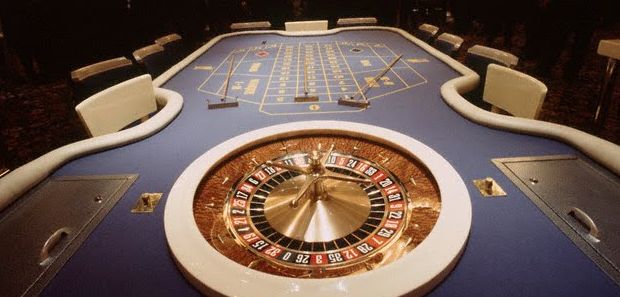 Roulette wheel with table at the end.