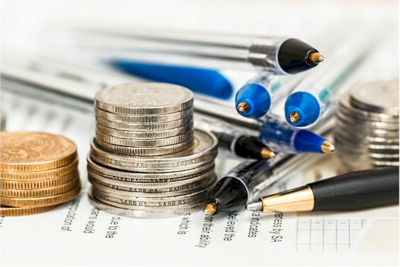 Stack of pens and coins.