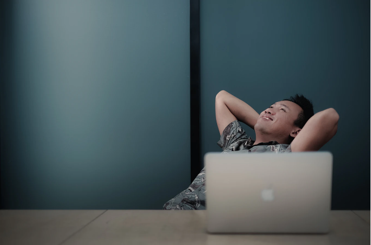 Man relaxing at computer